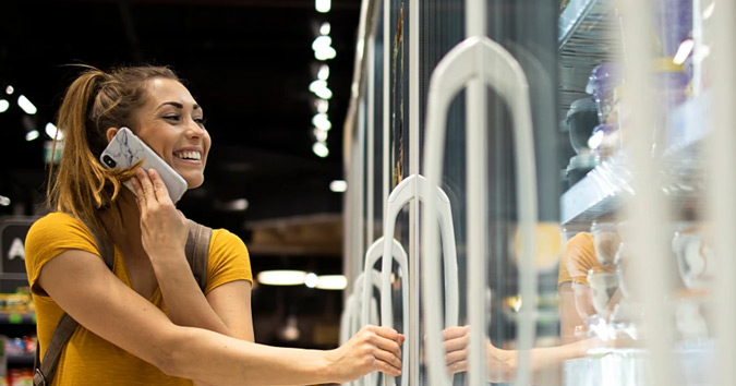 hp retailers woman opening grocery fridge