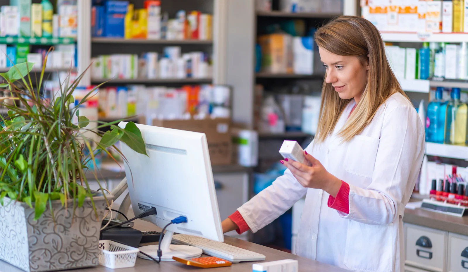 woman pharmacist looking at computer